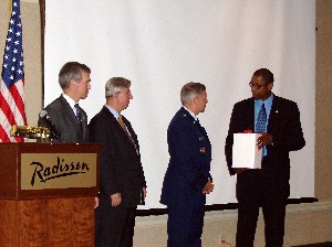 Dr. Donald Hanson (l), director, Air Force Research Laboratory Information Directorate; Wayne Bonser (2nd from l), conference chair, Airborne Network Technology Review Days; and Rick Lockridge (r), chapter president, present a token of appreciation to Lt. Gen. Robert J. Elder Jr., USAF, commander, 8th Air Force (Air Forces Strategic), Barksdale Air Force Base, Louisiana, and Joint Functional Component Commander for Global Strike and Integration, U.S. Strategic Command, Offutt Air Force Base, Nebraska, for his keynote presentation in August.